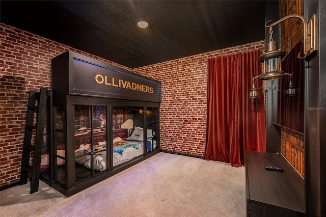 bedroom with carpet and brick wall