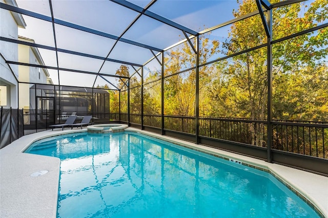 view of swimming pool with a lanai and an in ground hot tub