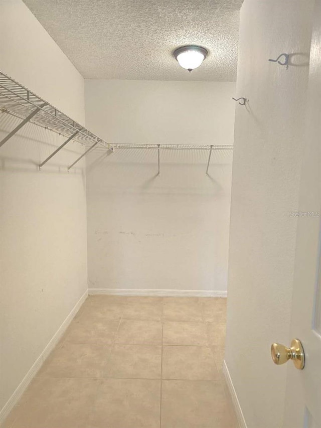 spacious closet with tile patterned floors