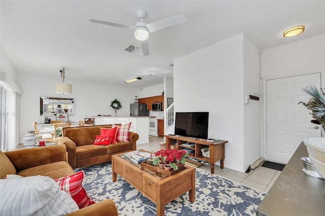 living room featuring ceiling fan and light tile patterned flooring