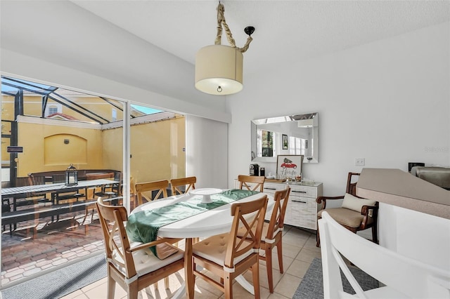 dining space featuring light tile patterned flooring