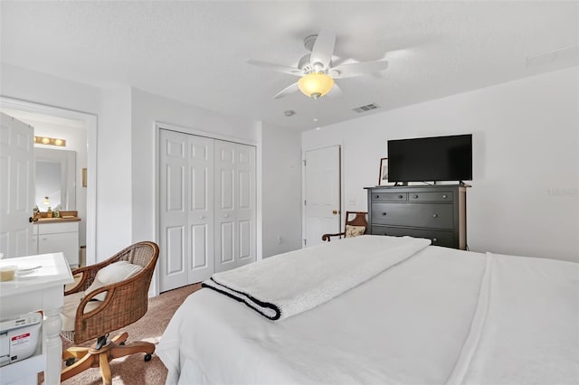 bedroom featuring carpet, ceiling fan, a textured ceiling, and a closet