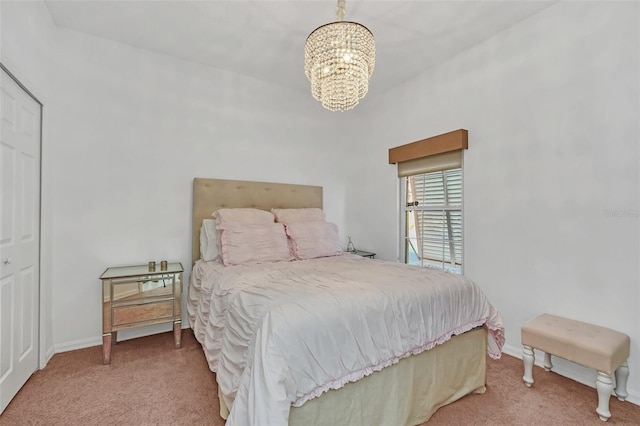 carpeted bedroom with a chandelier