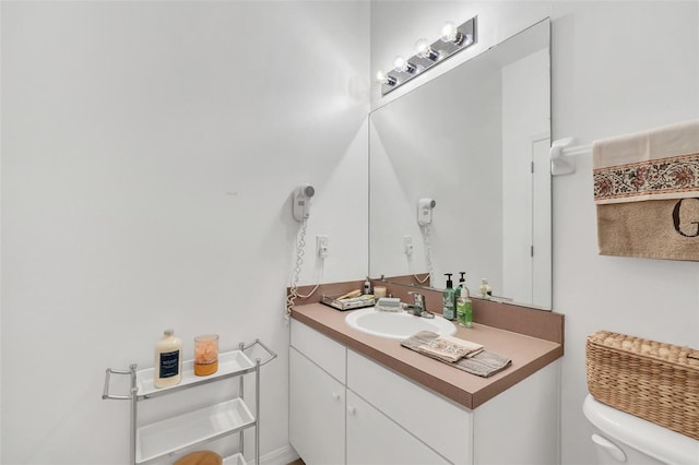 bathroom featuring vanity and toilet