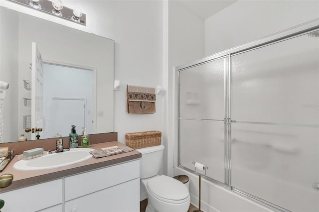 full bathroom featuring vanity, toilet, and enclosed tub / shower combo