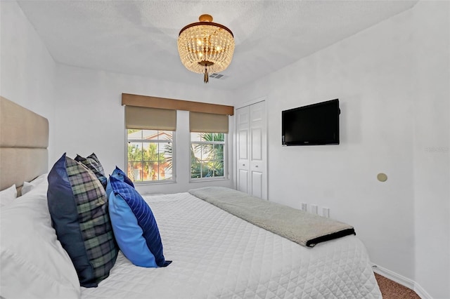 carpeted bedroom featuring a notable chandelier