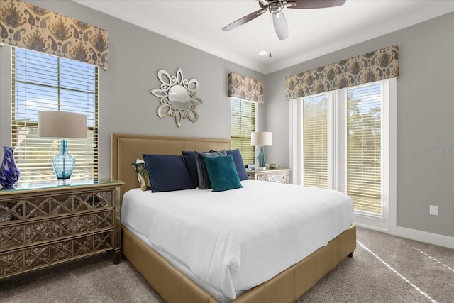 carpeted bedroom featuring ceiling fan and crown molding