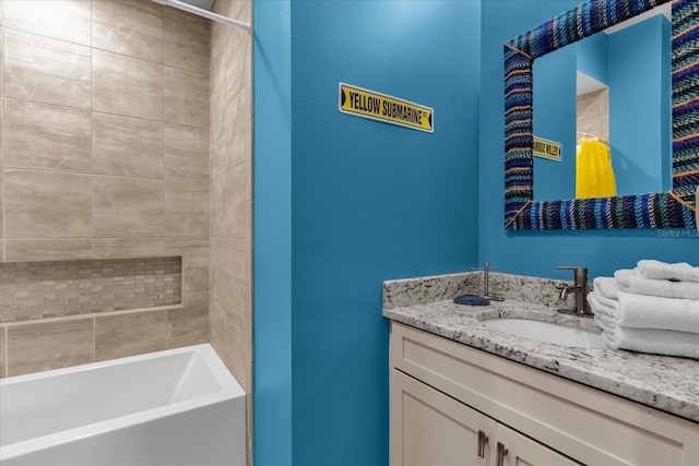 bathroom with vanity and tiled shower / bath