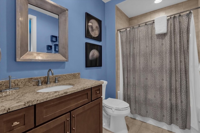 full bathroom featuring tile patterned flooring, vanity, toilet, and shower / bath combo with shower curtain