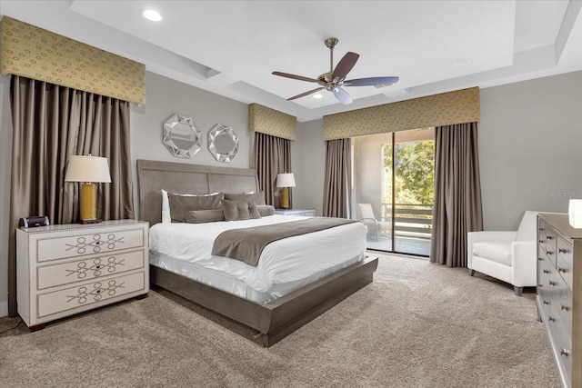 bedroom with access to exterior, carpet flooring, a raised ceiling, and ceiling fan