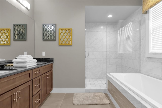 bathroom featuring tile patterned floors, vanity, and separate shower and tub