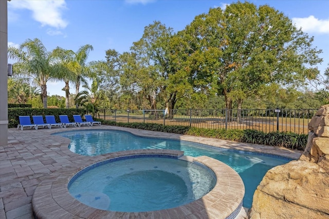 view of swimming pool with an in ground hot tub and a patio