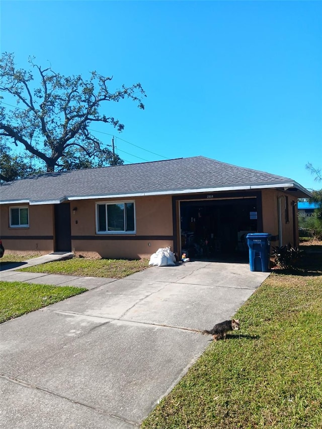 single story home with a garage and a front yard