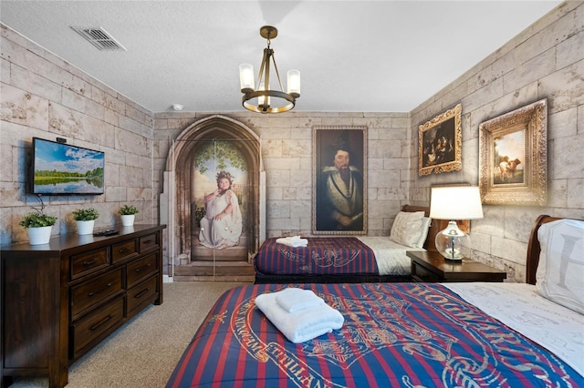 bedroom with light colored carpet, a textured ceiling, and a chandelier