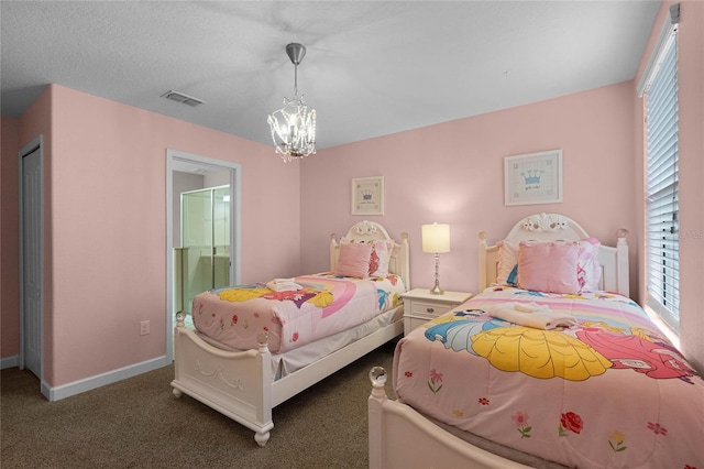 carpeted bedroom featuring connected bathroom and a notable chandelier