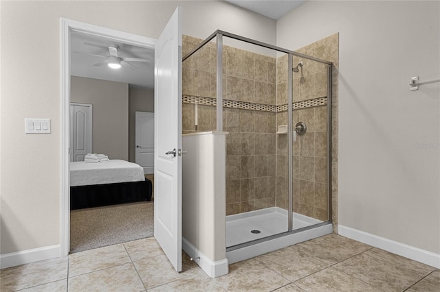 bathroom featuring a shower with door, ceiling fan, and tile patterned floors