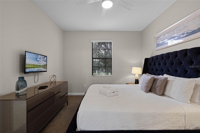 bedroom with ceiling fan and dark colored carpet