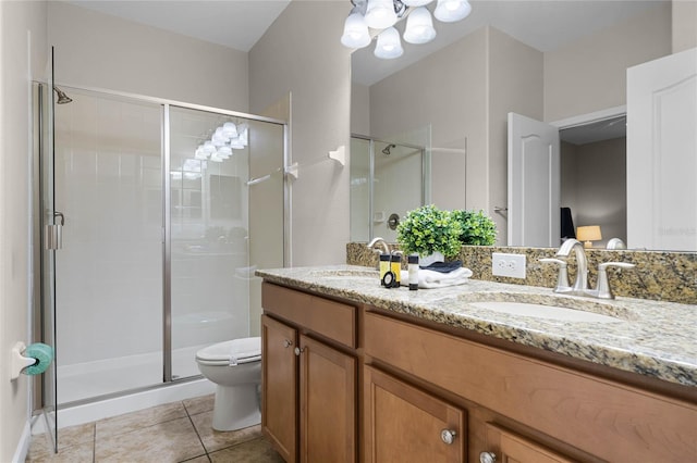 bathroom featuring toilet, walk in shower, vanity, tile patterned floors, and an inviting chandelier