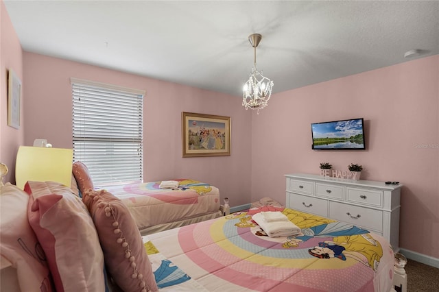 bedroom featuring a notable chandelier and carpet floors