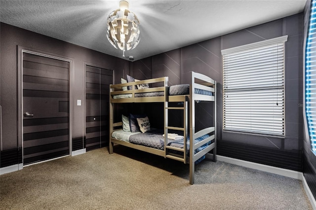 carpeted bedroom featuring a textured ceiling