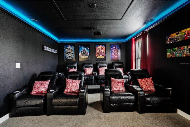 home theater room featuring a textured ceiling and carpet flooring