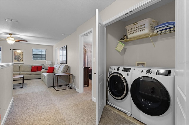 washroom featuring ceiling fan, light colored carpet, and washer and clothes dryer