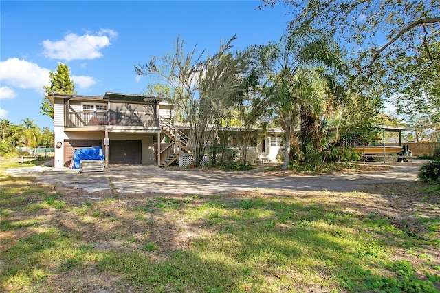 rear view of house featuring a garage