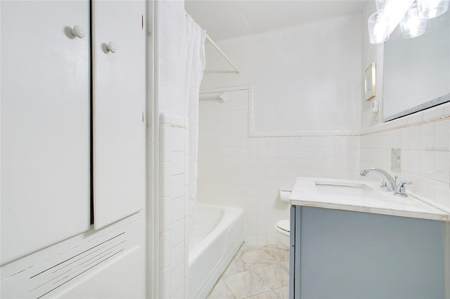 full bathroom featuring toilet, vanity, shower / bathtub combination with curtain, and tile walls