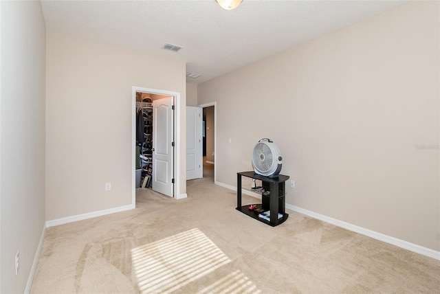 carpeted bedroom featuring a spacious closet