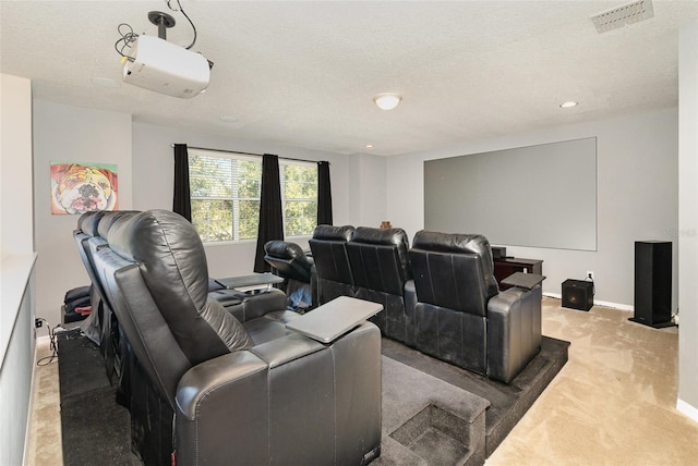 carpeted cinema featuring a textured ceiling