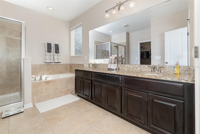 bathroom featuring tile patterned floors, vanity, and separate shower and tub