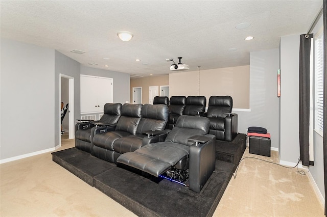 carpeted home theater featuring a textured ceiling