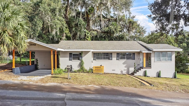 single story home featuring a front yard and a carport