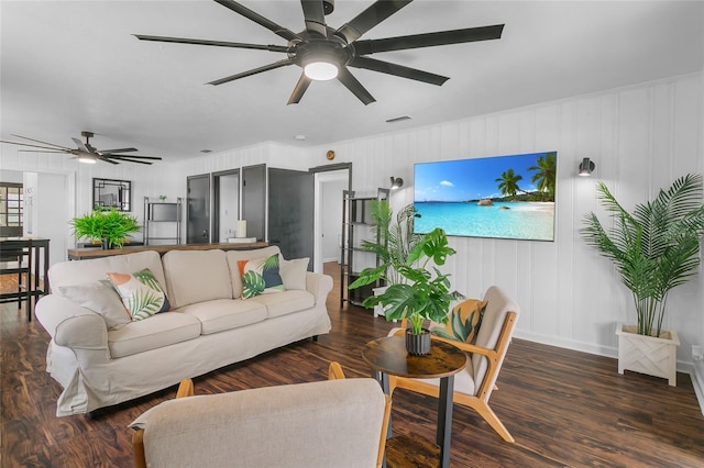 living room with dark hardwood / wood-style flooring and ceiling fan