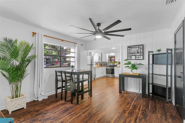 dining area with ceiling fan and dark hardwood / wood-style flooring