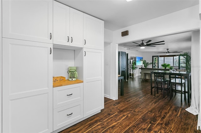 kitchen with ceiling fan, white cabinets, and dark wood-type flooring