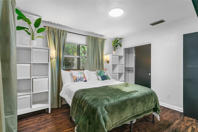 bedroom with dark hardwood / wood-style floors