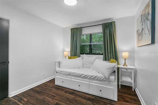 bedroom with dark hardwood / wood-style flooring