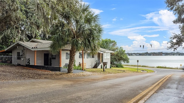 view of front of house with a water view