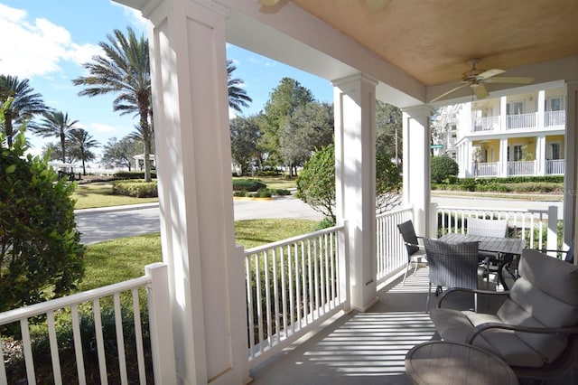 balcony featuring ceiling fan and a porch