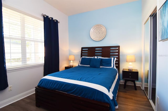 bedroom featuring a closet and dark hardwood / wood-style floors