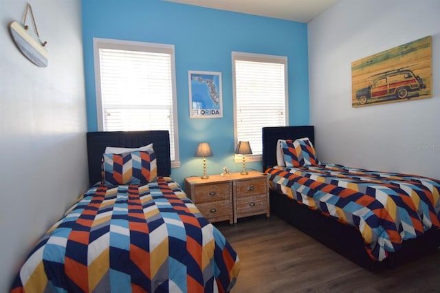 bedroom with dark hardwood / wood-style floors