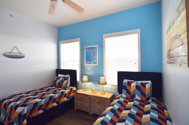 bedroom featuring multiple windows, ceiling fan, and dark hardwood / wood-style floors