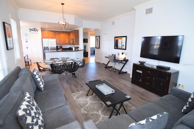 living room featuring wood-type flooring and ornamental molding