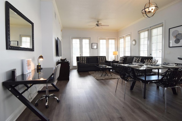 dining room featuring dark wood-type flooring, ceiling fan with notable chandelier, and ornamental molding