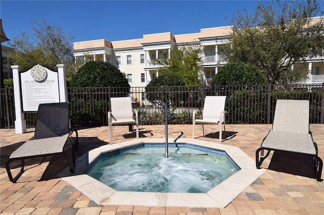 view of pool with a hot tub