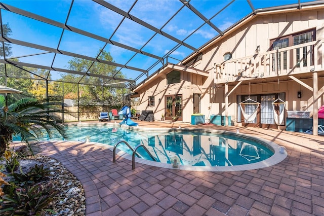 view of pool with a lanai and a patio