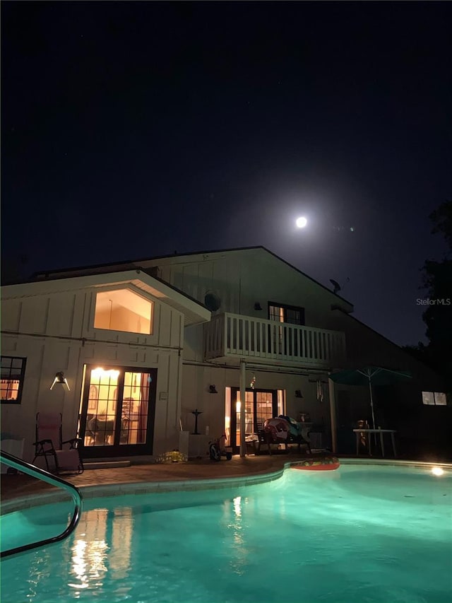 view of pool at night