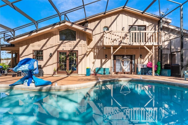 view of swimming pool with a patio area and a lanai