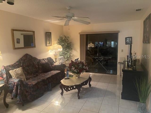 tiled living room with ceiling fan